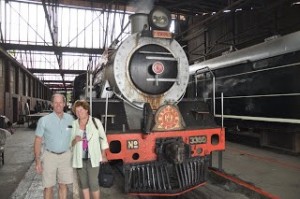 Old couple next to industrial train