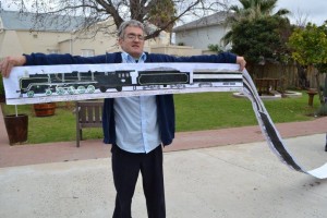 Man holding up sketches of the Rovos Train